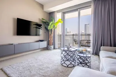 a living room with a tv and a large window at Frank Porter - 5242 Emaar Tower in Dubai