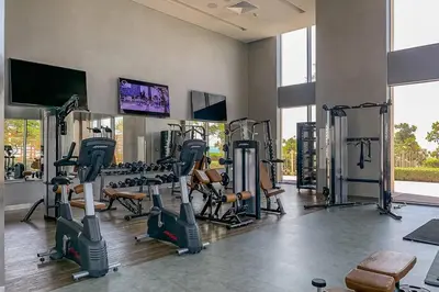 a gym with treadmills and tread machines in a room at Frank Porter - 5242 Emaar Tower in Dubai