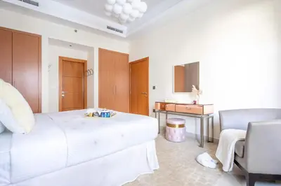 a bedroom with a bed and a desk and a chair at Frank Porter - Ocean Heights, Dubai Marina in Dubai
