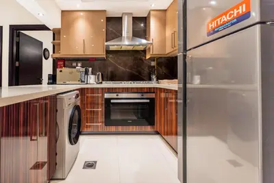 a kitchen with a washer and dryer at Escape24 2BR with Large Balcony near Burj Khalifa in Dubai