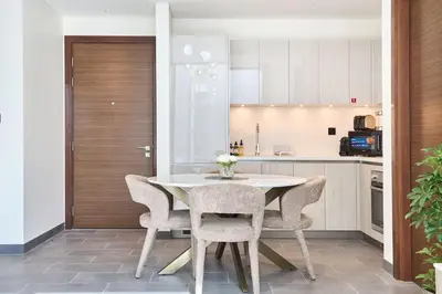 a kitchen with a white table and chairs at The Crest C Luxury Retreat Stylish & Serene in Dubai