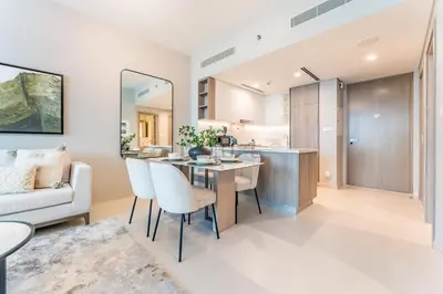 a kitchen and living room with a table and chairs at Luxury 1BR with Pool and Stunning Marina Views, Perfectly Located Minutes from the Beach, Tram, and Mall, LIV Marina, Dubai Marina by Deluxe Holiday Homes in Dubai