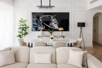 a white living room with a table and chairs at Stylish 1 Bedroom Apartment with Marina View JBR in Dubai