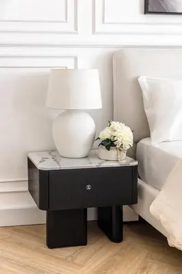 a table with a lamp on it next to a bed at Stylish 1 Bedroom Apartment with Marina View JBR in Dubai