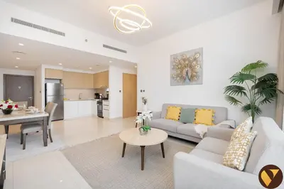 a living room with a couch and a table at Vogue Creek Harbour Icon Bay Waterfront Living Close to Downtown, Burj Khalifa and Dubai Mall, Two Bedroom Apartment with Large Balcony and Canal View, Access to all Amenities in Dubai