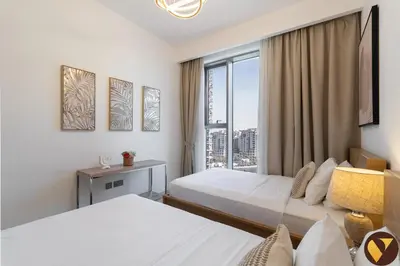 a hotel room with two beds and a window at Vogue Creek Harbour Icon Bay Waterfront Living Close to Downtown, Burj Khalifa and Dubai Mall, Two Bedroom Apartment with Large Balcony and Canal View, Access to all Amenities in Dubai