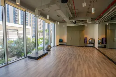 a large room with a large floor to ceiling windows at Vogue Creek Harbour Icon Bay Waterfront Living Close to Downtown, Burj Khalifa and Dubai Mall, Two Bedroom Apartment with Large Balcony and Canal View, Access to all Amenities in Dubai