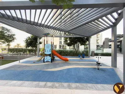 a playground with a slide and a slideintend at Vogue Creek Harbour Icon Bay Waterfront Living Close to Downtown, Burj Khalifa and Dubai Mall, Two Bedroom Apartment with Large Balcony and Canal View, Access to all Amenities in Dubai