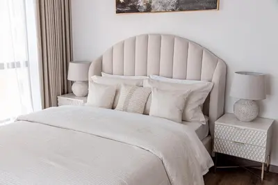 a white bedroom with a large white bed with white pillows at Beautiful 2 bed in JBR! bahar in Dubai