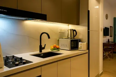 a kitchen with a sink and a microwave at City Stay Dubai South - Serviced Apartments in Dubai