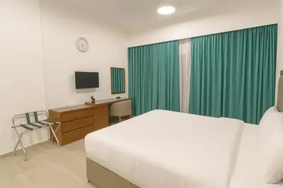a bedroom with a bed and a desk and a television at City Stay Dubai South - Serviced Apartments in Dubai