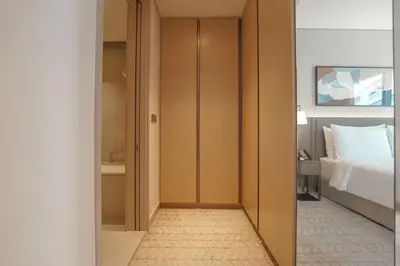 a hallway leading to a bedroom with a bed at Prime Stay Elite, Dubai Mall & Burj Khalifa View in Dubai