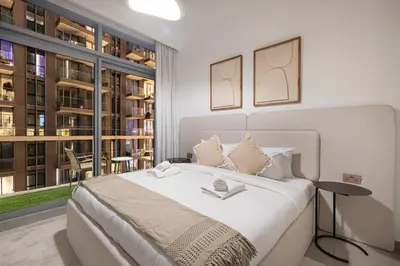 a bedroom with a large bed and a large window at Serene Beachfront Oasis Private Beach 4BR in Dubai