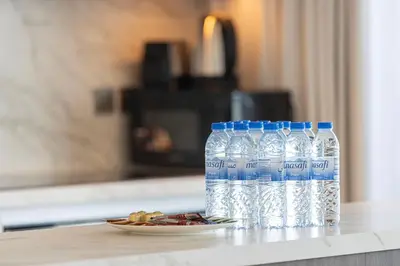 a couple of bottles of water sitting on a counter at Serene Beachfront Oasis Private Beach 4BR in Dubai