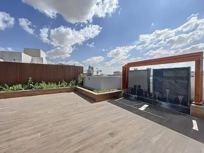 a balcony with chairs on a building with a sky at Locations l Peaceful 2 Bedroom l Community Views l Free Pool, Gym Access in Dubai