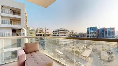 a balcony with a chair and a view of a city at Locations l Peaceful 2 Bedroom l Community Views l Free Pool, Gym Access in Dubai
