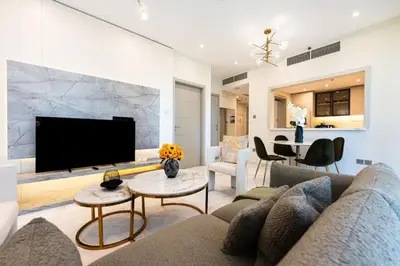 a living room with a couch and a flat screen tv at 1 BR Near Burj Khalifa & Dubai Mall - Downtown in Dubai