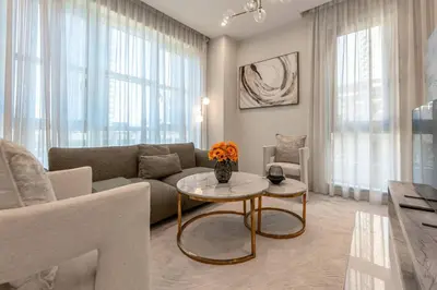 a living room with a couch and a table at 1 BR Near Burj Khalifa & Dubai Mall - Downtown in Dubai