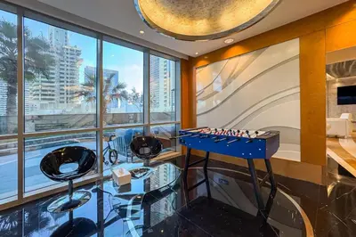 a game room with a chess board and stools at Spacious 2-Bed Marina Home with Wrap-Around Balcony in Dubai