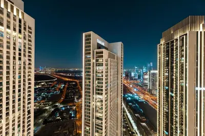 a night view of a city with tall buildings at The Iconic View - 3BR With Maid's Room - Burj Khalifa Area in Dubai
