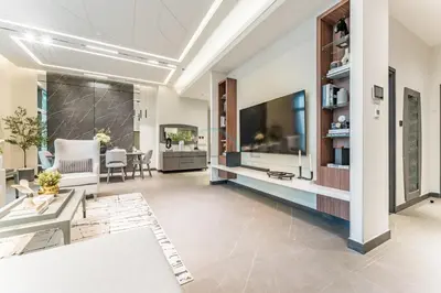 a living room with a large flat screen tv at Luxurious High-Floor 3BR with Assistant Room, Showcasing Lake & City Views, Just Moments Drive from JBR Beaches and Ain Dubai, MBL Royal, JLT by Deluxe Holiday Homes in Dubai
