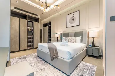 a bedroom with a large white bed in a room at Luxurious High-Floor 3BR with Assistant Room, Showcasing Lake & City Views, Just Moments Drive from JBR Beaches and Ain Dubai, MBL Royal, JLT by Deluxe Holiday Homes in Dubai