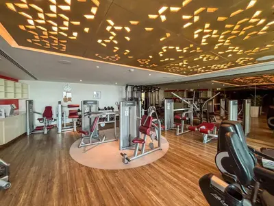 a gym with treadmills and exercise equipment on the ceiling at Frank Porter - Paramount Tower A in Dubai