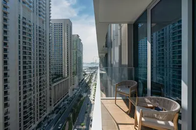 two views of a city from a building at Luxury 1BR with Private Beach & Pool! in Dubai