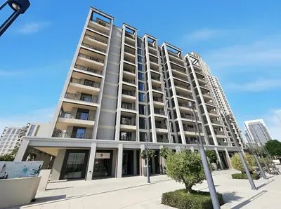 a tall apartment building on a city street at Bright 1BR with Balcony Creek Beach Access in Dubai