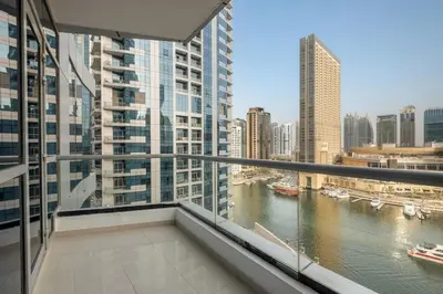 a balcony with a view of a river and buildings at FIRST CLASS 1BR Scenic Marina Views in Dubai