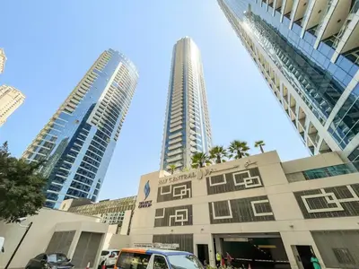 two tall buildings in a city with a building at FIRST CLASS 1BR Scenic Marina Views in Dubai