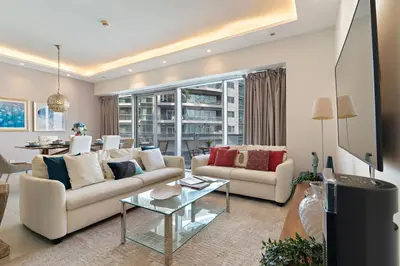 a living room with two couches and a table at The Smart Concierge - Marina tower in Dubai