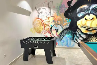 a black stool in front of a wall with graffiti at Joya Verde Residence - Studio with Balcony in Dubai