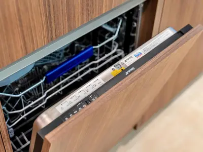 a dishwasher with a remote control in it at Royal Vista - Luxe 4BR Penthouse with Burj Khalifa View at Imperial Avenue - Downtown in Dubai