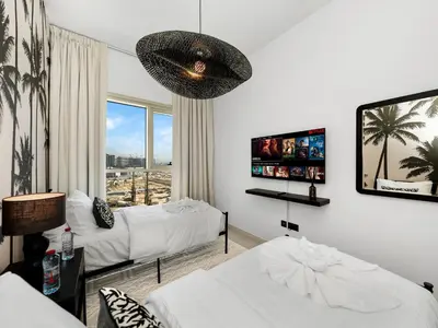 a bedroom with two beds and a large window at Modern 2 Bed in Dubai Hills Near Mall & Park in Dubai