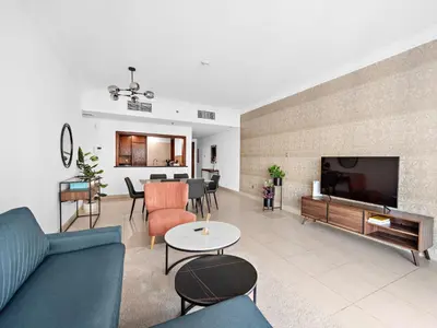 a living room with a couch and a tv at Luxury 2-BDR in Downtown 8 BLVD Walk in Dubai