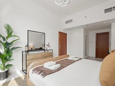 a bedroom with a bed and a mirror at Prime Luxe 1BR w SofaBed -Sleeps 4 - In Marina View in Dubai