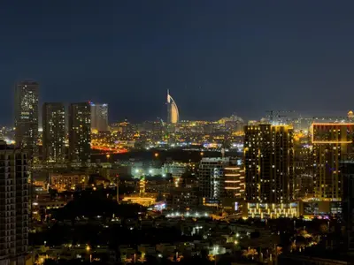 a view of a city at night with lights at GuestReady - 1 BHK | Breathtaking Skyline Views in Dubai