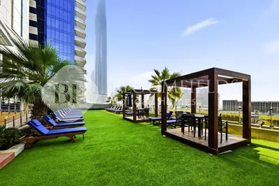 a group of chairs and tables on a lawn on a building at Bloomfields Iconic 2BR Elite Residence Marina in Dubai