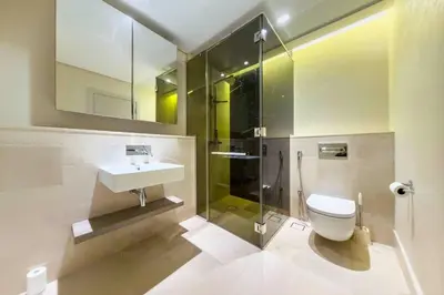 a bathroom with a toilet and a sink and a shower at Palm Jumeirah, Fancy 2 Bedroom suite! in Dubai