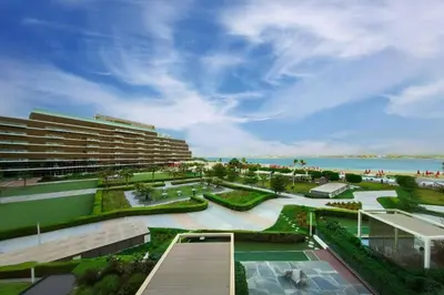 a view of a resort with the ocean in the background at Palm Jumeirah, Fancy 2 Bedroom suite! in Dubai