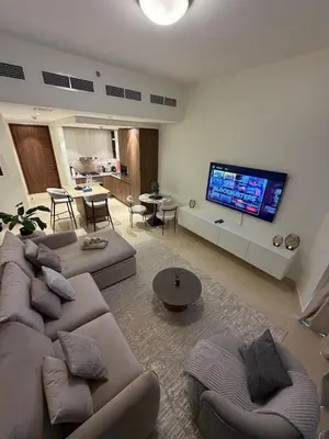 a living room with a couch and a flat screen tv at Magical Views Downtown Lux 2 BR Urban Resort in Dubai