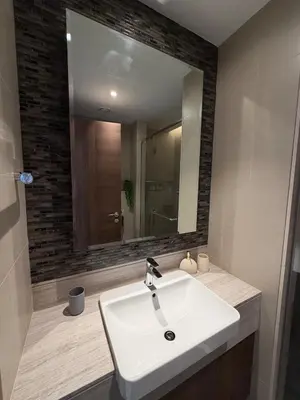 a bathroom with a white sink and a mirror at Magical Views Downtown Lux 2 BR Urban Resort in Dubai