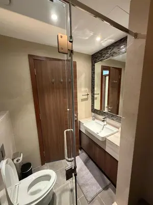 a bathroom with a toilet and a sink and a mirror at Magical Views Downtown Lux 2 BR Urban Resort in Dubai