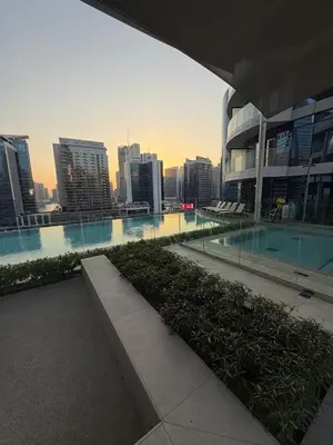 a view of a city skyline with a swimming pool at Magical Views Downtown Lux 2 BR Urban Resort in Dubai