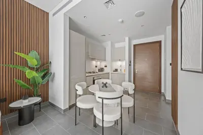 a dining room with a table and chairs and a kitchen at Luxury 1BR Apartment Near Burj Khalifa Skyline Pool View in Dubai
