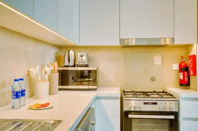 a kitchen with a stove and a microwave at PVH - Serene Central 2BR - Creek Horizon in Dubai