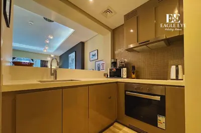 a kitchen with a sink and a stove top oven at EEHH 1BR - 8 day NYE festival - Paramount - for 4 in Dubai