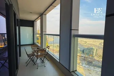 a balcony with tables and chairs in a building at EEHH 1BR - 8 day NYE festival - Paramount - for 4 in Dubai