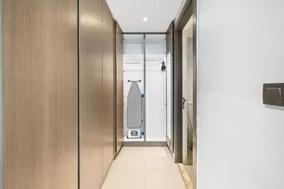 a hallway with wooden doors and a surfboard on the wall at Beautiful unit with canal view ! DAMAC PRIVE in Dubai